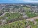 Expansive aerial view of a property nestled amongst trees and featuring a winding road leading to a wooded area at 242 Weathers Farm Rd, Bowman, SC 29018