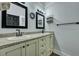 Bright bathroom featuring dual sinks, granite countertops, and framed mirrors at 242 Weathers Farm Rd, Bowman, SC 29018