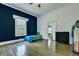 Bright bedroom featuring a single bed, blue accent wall, and wood flooring at 242 Weathers Farm Rd, Bowman, SC 29018