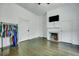 Open bedroom with white walls, wood flooring, and a fireplace at 242 Weathers Farm Rd, Bowman, SC 29018