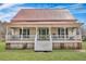 Charming two-story home featuring a large front porch, green door and a distinctive red metal roof at 242 Weathers Farm Rd, Bowman, SC 29018
