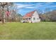 Exterior of home featuring a red metal roof, and a manicured lawn and established trees at 242 Weathers Farm Rd, Bowman, SC 29018