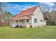 Exterior of a home with a red metal roof, a covered porch, and fresh green grass at 242 Weathers Farm Rd, Bowman, SC 29018