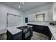Spacious kitchen with an island, white cabinets, black lower cabinets, and neutral-toned countertops at 242 Weathers Farm Rd, Bowman, SC 29018