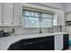 Bright kitchen featuring white cabinets and black lower cabinets, accented by neutral-toned counters at 242 Weathers Farm Rd, Bowman, SC 29018