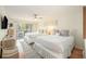 Bright bedroom featuring two beds, a ceiling fan, and sliding glass doors to a balcony at 27 Lagoon Villas, Isle of Palms, SC 29451