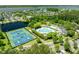 An aerial view of community amenities with a pool, clubhouse, tennis and basketball courts surrounded by a lake and trees at 2788 Carolina Isle Dr, Mount Pleasant, SC 29466