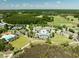 Aerial view showcasing a community center with a pool, tennis courts, ample parking, and a manicured golf course at 2788 Carolina Isle Dr, Mount Pleasant, SC 29466