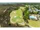 An aerial view of a golf course with water features next to luxury homes with a community pool in the background at 2788 Carolina Isle Dr, Mount Pleasant, SC 29466