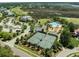 A high angle view of a community clubhouse, pool, and tennis courts surrounded by golf course and wooded areas at 2788 Carolina Isle Dr, Mount Pleasant, SC 29466