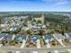 Expansive aerial view featuring a residential neighborhood surrounded by lush greenery and a well-maintained golf course at 2788 Carolina Isle Dr, Mount Pleasant, SC 29466