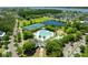 Overhead shot of community amenities including a pool, tennis courts, playground, and lake surrounded by green trees and homes at 2788 Carolina Isle Dr, Mount Pleasant, SC 29466