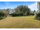 Spacious fenced backyard featuring a sprawling lawn and mature trees, perfect for outdoor activities at 2788 Carolina Isle Dr, Mount Pleasant, SC 29466