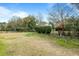 Expansive backyard with lush landscaping and a serene atmosphere, framed by a classic black fence at 2788 Carolina Isle Dr, Mount Pleasant, SC 29466