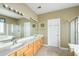 Bathroom with a double vanity and tile floors with framed mirrors and a glass shower door at 2788 Carolina Isle Dr, Mount Pleasant, SC 29466
