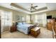 Comfortable bedroom with tray ceiling, carpet flooring, and natural light from windows at 2788 Carolina Isle Dr, Mount Pleasant, SC 29466