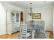Charming dining room with vintage cabinet, chandelier, and oval table set on a decorative rug at 2788 Carolina Isle Dr, Mount Pleasant, SC 29466