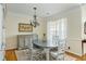 Elegant dining room features a stylish chandelier, grey accent furniture and natural light at 2788 Carolina Isle Dr, Mount Pleasant, SC 29466