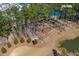 Aerial view of a dog park featuring fenced areas and lush greenery next to a retention pond at 282 Great Lawn Dr, Summerville, SC 29486