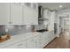 Well-lit kitchen featuring stainless steel appliances, white cabinets, and grey tile backsplash at 282 Great Lawn Dr, Summerville, SC 29486