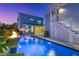 Evening view of modern pool with fire bowls, lounge seating and nearby staircase at 282 Great Lawn Dr, Summerville, SC 29486