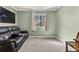 Bedroom with a window, black peg board with a flag, and a leather couch at 2915 Nantuckett Ave, North Charleston, SC 29420