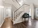 Welcoming foyer with hardwood floors, white staircase, and stylish console table at 2915 Nantuckett Ave, North Charleston, SC 29420