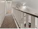 Upstairs hallway with neutral carpet, white railing, and a view looking down on the staircase at 2915 Nantuckett Ave, North Charleston, SC 29420