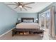 Bright main bedroom with a ceiling fan, bench with shoe storage, and sliding glass doors to a deck at 2915 Nantuckett Ave, North Charleston, SC 29420