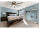 This main bedroom has a ceiling fan, carpet, a door to the deck, and a bench for shoe storage at 2915 Nantuckett Ave, North Charleston, SC 29420