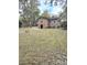 Property featuring a grassy backyard, mature trees and home exterior view with a small outdoor shed at 313 Springwood Dr, Walterboro, SC 29488