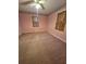 Bedroom with neutral carpet, vintage floral wallpaper border, and traditional wooden window shutters at 313 Springwood Dr, Walterboro, SC 29488