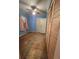 Bright bedroom featuring hardwood floors, a ceiling fan, louvered closet doors, and ample natural light at 313 Springwood Dr, Walterboro, SC 29488