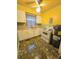 Retro kitchen features bright yellow walls, tile flooring, and white appliances at 313 Springwood Dr, Walterboro, SC 29488