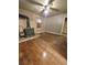 Living room with hardwood floors, black fireplace, ceiling fan, and natural light from windows at 313 Springwood Dr, Walterboro, SC 29488