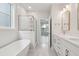 Open view of a bathroom featuring a soaking tub, glass shower, and a double vanity with modern fixtures at 3154 Vanessa Lynne Ln, Johns Island, SC 29455