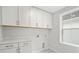 Bright laundry room with white cabinets, marble counters and patterned floor at 3154 Vanessa Lynne Ln, Johns Island, SC 29455