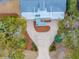Aerial view of home with well manicured lawn and curved driveway with mature trees at 3204 Waterway Blvd, Isle of Palms, SC 29451