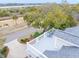 Aerial view of a rooftop deck overlooking a lush, green landscape with trees and a waterfront community at 3204 Waterway Blvd, Isle of Palms, SC 29451