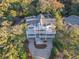 Stunning aerial view of a two-story coastal home with multiple balconies surrounded by lush greenery at 3204 Waterway Blvd, Isle of Palms, SC 29451