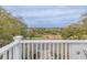 An aerial view overlooks a tree-filled backyard, and waterway in the distance at 3204 Waterway Blvd, Isle of Palms, SC 29451