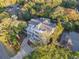 Lovely aerial view of a home with mature trees, gray roof, and beautiful landscaping at 3204 Waterway Blvd, Isle of Palms, SC 29451