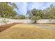 A backyard features a grassy lawn, a gravel path, and a white fence with a gate at 3204 Waterway Blvd, Isle of Palms, SC 29451