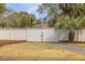 A backyard features a grassy lawn, a gravel path, and a white fence with a gate at 3204 Waterway Blvd, Isle of Palms, SC 29451