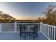 Balcony with seating offers relaxing outdoor space with sunset views over the trees and water at 3204 Waterway Blvd, Isle of Palms, SC 29451