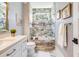 Well-lit bathroom featuring a bathtub, shower, vanity, and neutral tile work at 3204 Waterway Blvd, Isle of Palms, SC 29451