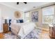 Bright bedroom with a king bed, wood floors, serene natural light from multiple windows, and ceiling fan at 3204 Waterway Blvd, Isle of Palms, SC 29451