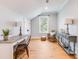 Bright bedroom featuring hardwood floors, a work desk, and a cozy sitting area by the window at 3204 Waterway Blvd, Isle of Palms, SC 29451