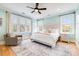 Bright and airy bedroom featuring a king bed, custom headboard, and two side tables with arm chair at 3204 Waterway Blvd, Isle of Palms, SC 29451