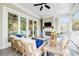 Relaxing covered patio with cozy seating, a fireplace, and views of the lush backyard, ideal for year-round enjoyment and gatherings at 3204 Waterway Blvd, Isle of Palms, SC 29451